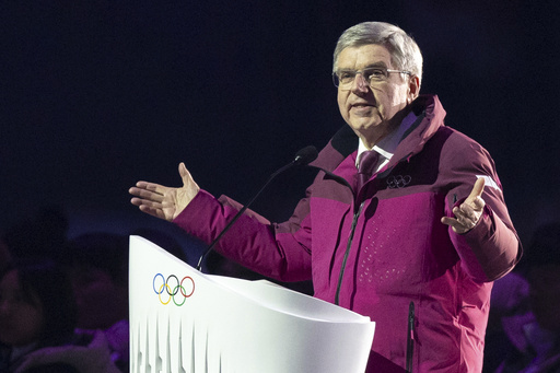 In this image issued by Olympic Information Services/IOC, International Olympic Committee (IOC) president Thomas Bach, center, speaks during the opening ceremony of the Gangwon 2024 Winter Youth Olympic Games at the Gangneung Oval, in Gangneung, South Korea, Friday, Jan. 19, 2024. (Chloe Knott/OIS/IOC for OIS via AP)