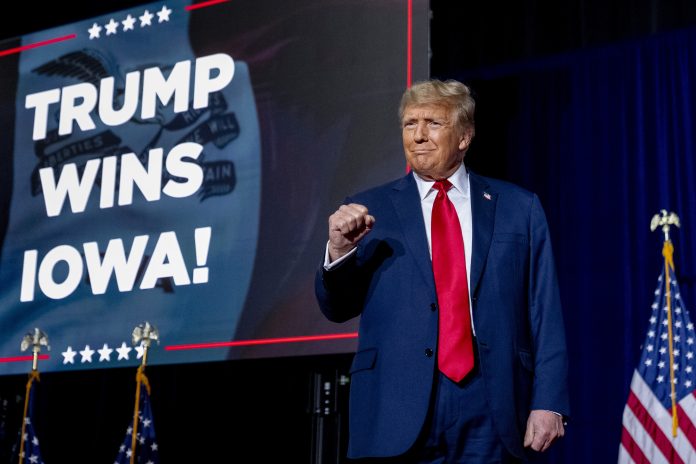 Republican presidential candidate former President Donald Trump takes the stage at a caucus night party in Des Moines, Iowa