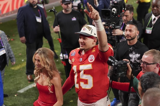 Kansas City Chiefs quarterback Patrick Mahomes walks off the field with his wife Brittany Mahomes after the NFL Super Bowl 58 football game against the San Francisco 49ers on Sunday, Feb. 11, 2024, in Las Vegas. The Chiefs won 25-22 against the 49ers. (AP Photo/Abbie Parr)