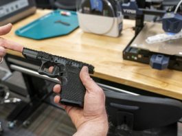 A handgun frame that has been printed on a 3D printer is held for a photograph at the Bureau of Alcohol, Tobacco, Firearms, and Explosives (ATF), National Services Center, Thursday, March 2, 2023, in Martinsburg, W.Va. Machine guns have been illegal in the U.S. for decades, but in recent years the country has seen a new surge of weapons capable of automatic fire. Small pieces of plastic or metal used to convert legal guns into homemade machine guns are helping to fuel gun violence. (AP Photo/Alex Brandon)