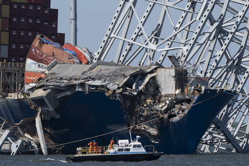 Collapsed Baltimore bridge span comes down with a boom after crews set off chain of explosives