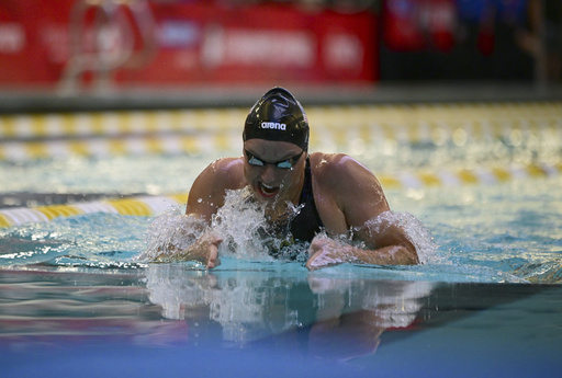 While Simone Biles competes across town, Paralympic star Jessica Long rolls at swimming trials