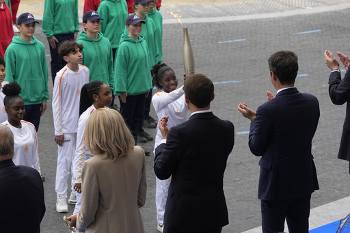 Various Individuals, Including a BTS Member and a Sanitation Worker, Carry the Olympic Torch Through Paris