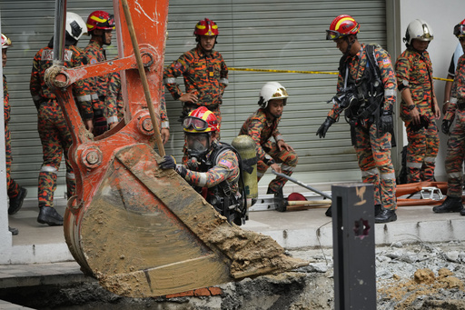 Woman falls into 8-meter-deep hole as pavement collapses in Malaysia