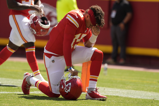 Patrick Mahomes of the Chiefs successfully executes a behind-the-back pass to Travis Kelce during a preseason matchup against Detroit