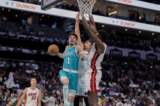 Jimmy Butler nets 13 of his 26 points in the final quarter, leading the Heat to a 114-106 victory over the determined Hornets.