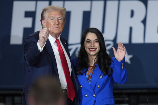 Trump listens to an individual who resided illegally in the US during a Latino campaign rally.