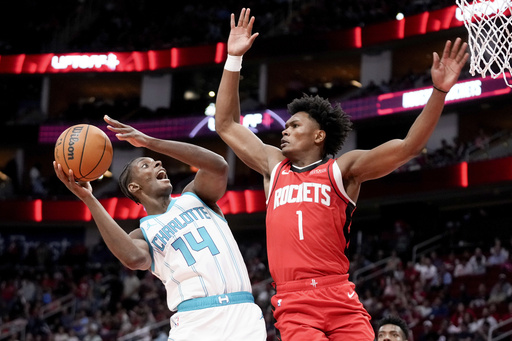 Ball scores 34 points and dishes out 11 assists in comeback from ankle injury, guiding Hornets to a 110-105 victory against Rockets.