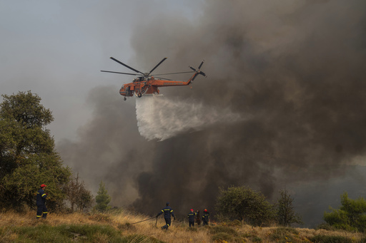 Hundreds of firefighters battle a deadly forest fire raging in southern Greece for the third day