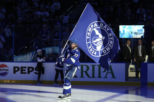 Power utility employees receive accolades during the Lightning’s postponed home opener due to hurricane impacts.