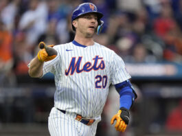 New York Mets' Pete Alonso (20) tosses his bat as he watches his solo home run sail over the right field wall against the Philadelphia Phillies during the second inning of Game 3 of the National League baseball playoff series, Tuesday, Oct. 8, 2024, in New York. (AP Photo/Frank Franklin II)