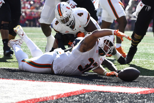 Cam Ward tosses 4 TDs as No. 6 Miami escapes with a thrilling 52-45 victory over Louisville’s comeback attempts.