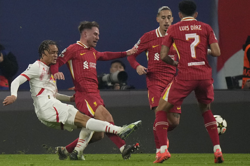 Xavi Simons of Leipzig assisted off the pitch due to injury during Champions League match