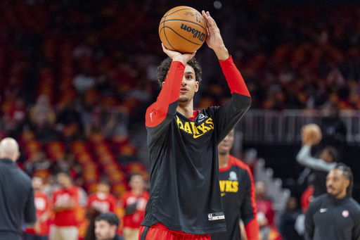 Top pick Risacher from Atlanta scores his first NBA basket, pledging to improve consistently.