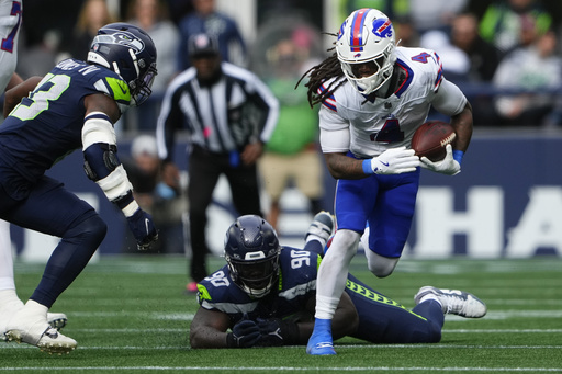 Seahawks players Derick Hall and Jarran Reed had a sideline disagreement during defeat against the Bills.