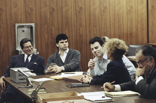 FILE - Erik Menendez, center, listens to his attorney Leslie Abramson, as his brother Lyle looks on in a Beverly Hills, California, May 17, 1991. (AP Photo/Julie Markes, File)