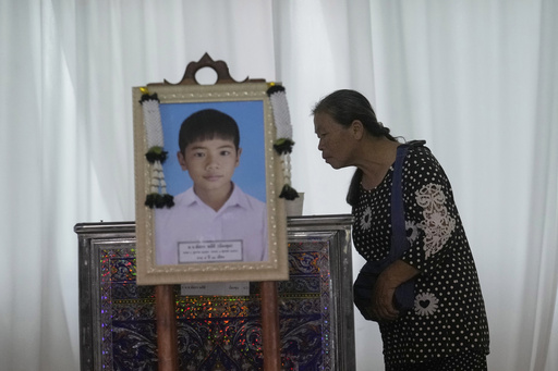 Memories and prayers are shared at a small-town funeral for the victims of horrific Thai bus fire