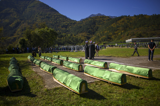 Numerous attendees gather for a funeral in southern Bosnia honoring the 19 victims of severe flooding.