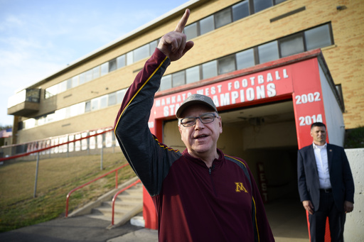 Walz walks through high grass in Minnesota as pheasant hunting season starts, but doesn’t catch any birds.