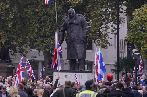 Far-right British figure’s supporters gather while anti-racism protesters hold counter-demonstration.