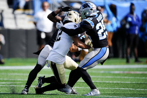 Saints wide receiver Chris Olave placed on a backboard and removed from the field following collision