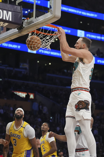 LeBron James secures his third consecutive triple-double while leading the Lakers to a 128-123 comeback win against the Grizzlies.