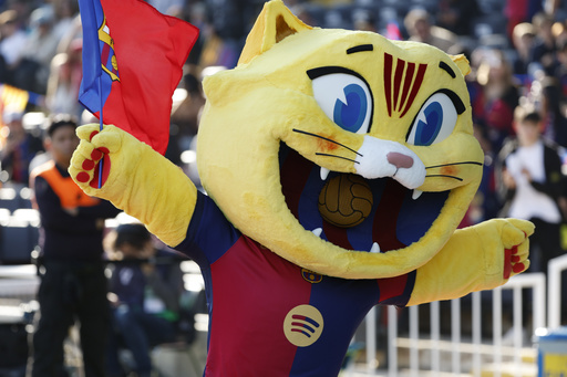 Barcelona introduces its new cat mascot during a home match.