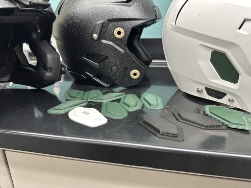 Michigan State University engineering professor and student create helmet liners to reduce crowd noise interference for quarterbacks.