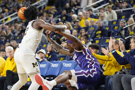 Nimari Burnett tallies 16 points while Danny Wolf achieves a double-double, guiding Michigan to a 76-64 victory over TCU.