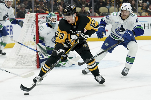 Rust leads Penguins to a 5-4 victory over Canucks, ending three-game losing streak