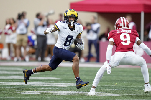 No. 8 Indiana secures school-record 10th victory by defeating Michigan 20-15 with two early touchdowns.