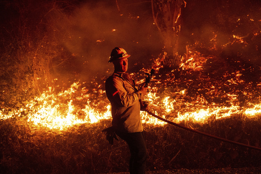 Wildfire in Southern California devastates 132 buildings as officials await calmer winds.