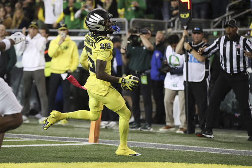 Top-ranked Oregon loses star wide receiver and punt returner Tez Johnson to suspected injury early in matchup with Michigan