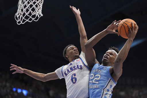 Top-ranked Kansas survives against No. 9 North Carolina after nearly losing substantial advantage in showdown of basketball giants