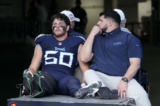 Titans linebacker Jack Gibbens taken off the field with a right ankle injury in a protective air cast.