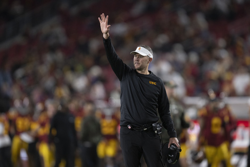 NCAA imposes one-year probation and $50,000 fine on USC football for breaching coaching staff regulations.