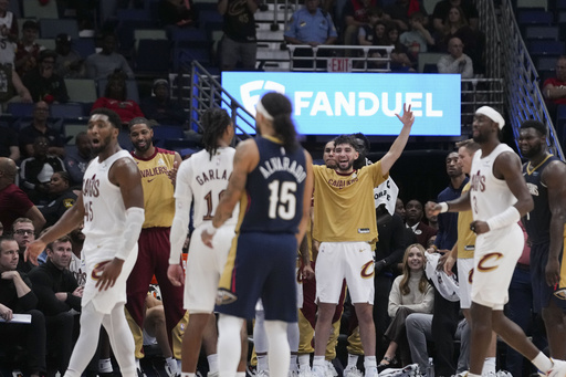 Cavaliers celebrate their unprecedented 9-0 beginning by dousing coach Kenny Atkinson with water.