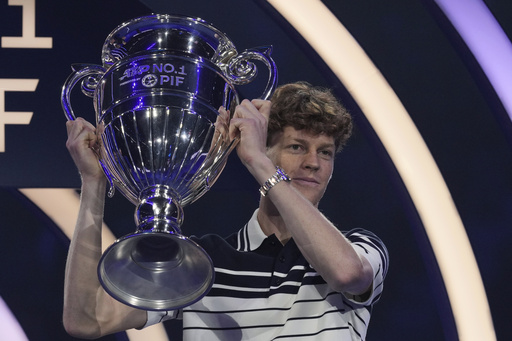 Sinner receives the trophy for achieving the top spot in the ATP rankings for the year.