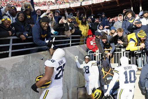 Police use pepper spray to disperse brawl between Michigan and Ohio State fans following Wolverines’ surprising 13-10 victory.