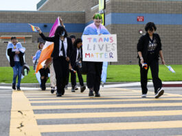 FILE - Students carrying pride and transgender flags leave Great Oak High School in Temecula, Calif., Friday, Sept. 22, 2023, after walking out of the school in protest of the Temecula school district policy requiring parents to be notified if their child identifies as transgender. (Anjali Sharif-Paul/The Orange County Register via AP, File)