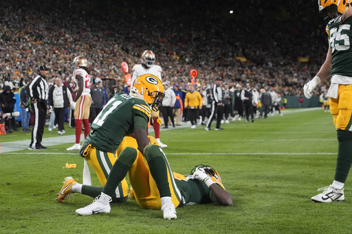 Packers receiver Romeo Doubs exits game due to concussion injury.