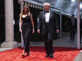 Melania Trump looks on as President-elect Donald Trump arrives for a New Year's Eve party at Mar-a-Lago, Tuesday, Dec. 31, 2024, in Palm Beach, Fla. (AP Photo/Evan Vucci)