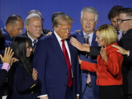 Republican presidential nominee former President Donald Trump is prayed over with Pastor Paula White during the National Faith Summit at Worship With Wonders Church, Monday, Oct. 28, 2024, in Powder Springs, Ga. (AP Photo/Brynn Anderson)