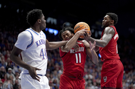 Mayo contributes 26 points while Dickinson records 21 points and 14 rebounds as No. 10 KU defeats NC State, 75-60.