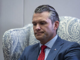 Pete Hegseth, President-elect Donald Trump's nominee to be defense secretary, listens to reporters during a meeting with Sen. Mike Rounds, R-S.D., a member of the Senate Armed Services Committee, at the Capitol in Washington, Thursday, Dec. 5, 2024. (AP Photo/J. Scott Applewhite)