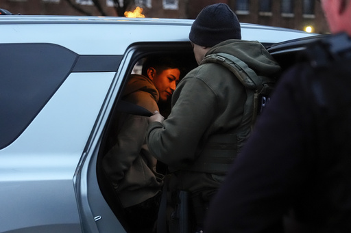 Deportation officers with Enforcement and Removal Operations in U.S. Immigration and Customs Enforcement's New York City field office arrest Wilmer Patricio Medina-Medina during an early morning operation, Tuesday, Dec. 17, 2024, in the Bronx borough of New York. (AP Photo/Julia Demaree Nikhinson)