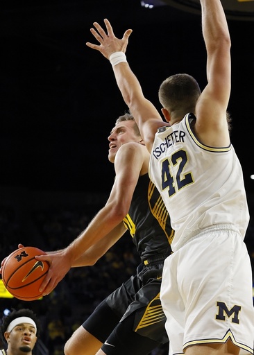 Gayle nets crucial basket late, leading Michigan to 85-83 triumph over Iowa and securing their 7th consecutive win.