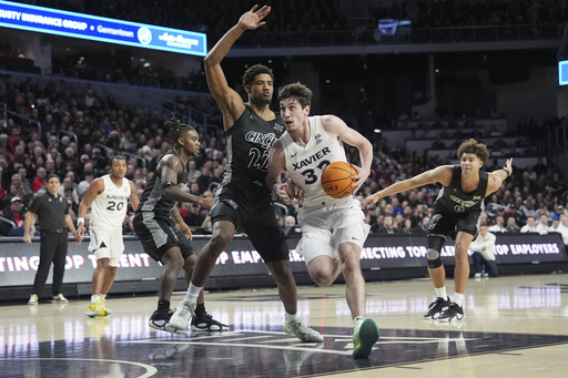 Cincinnati, ranked 22nd, defeats Xavier 68-65, ending a five-game losing streak versus their local rival.