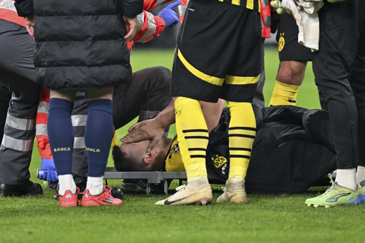 Nico Schlotterbeck of Dortmund carried off on stretcher due to ankle injury during defeat against Barcelona