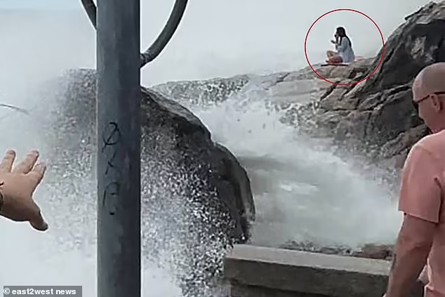 She was seen sitting on her yoga mat as the waves grew stronger and stronger

